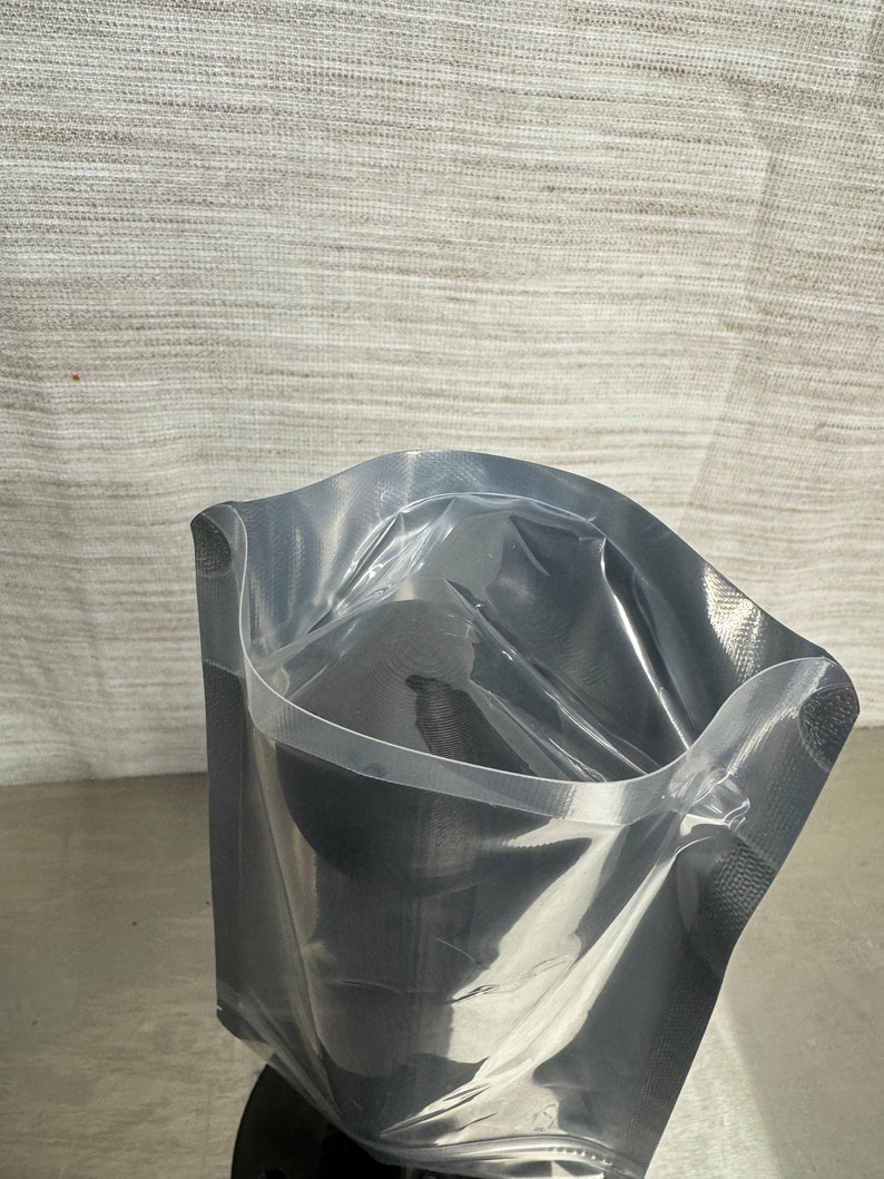 May include: A clear plastic vacuum seal bag with a zip closure. The bag is empty and ready to be used for food storage.