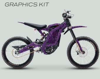 May include: A purple and black camouflage graphic kit for a Surron Light Bee X electric motorcycle. The kit includes a full cover design and is laminated for durability.  The kit is available for purchase from 101GFX.