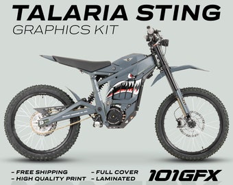 May include: A gray electric dirt bike with a shark graphic and the text "Military Shark" on the side. The bike has a black seat and black wheels. The text "101GFX" is printed on the bottom of the image.