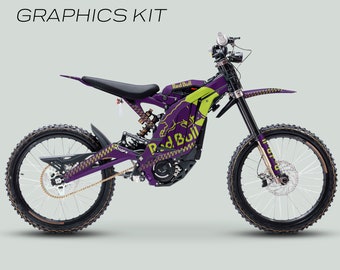 May include: A purple and green Surron Light Bee X electric dirt bike with Red Bull branding. The bike has a black seat and gold chain. The graphics kit is for a full cover, laminated design.