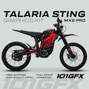 May include: Black and red Talaria Sting MX5 Pro graphics kit. The electric dirt bike features a red and black design with the Red Bull logo. The text "TALARIA STING GRAPHICS KIT MX5 PRO" is displayed at the top.