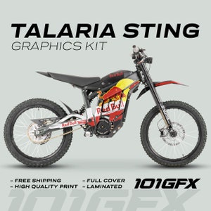 May include: A black and red electric dirt bike with a Red Bull graphic kit. The bike has a black seat, black handlebars, and black wheels with white spokes. The bike is on a white background.