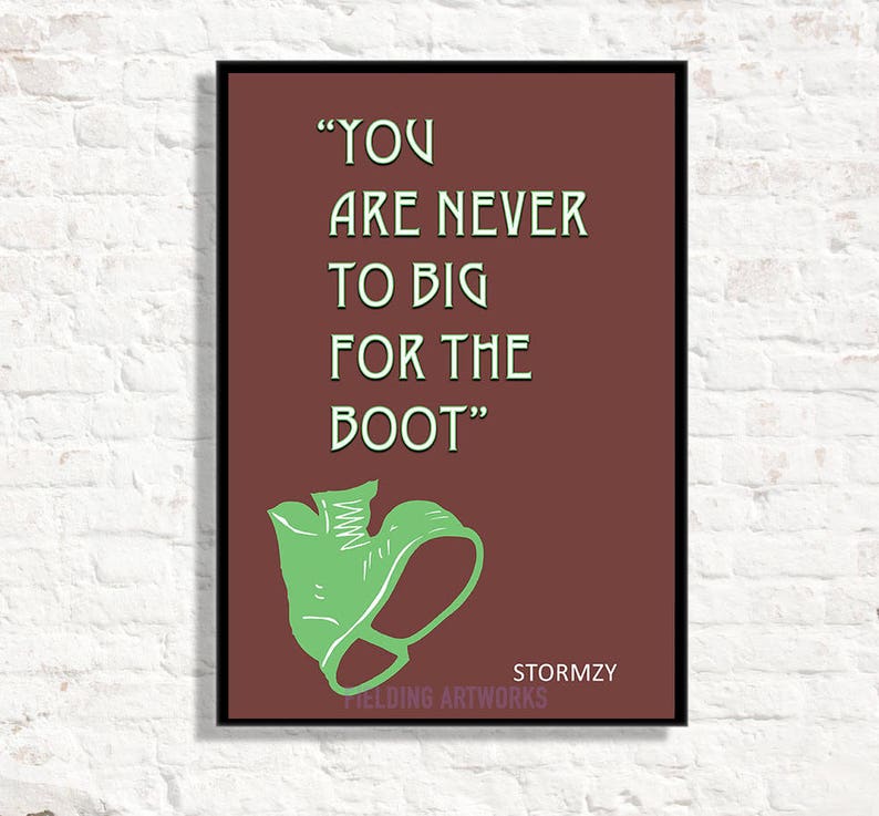 May include: A brown framed print with a white background and green text that reads "YOU ARE NEVER TO BIG FOR THE BOOT". The text is in a bold, sans-serif font. Below the text is a green illustration of a boot. The print is signed "Stormzy" and "Fielding Artworks" in white text.