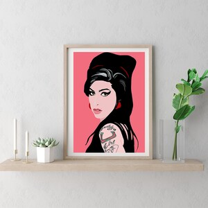 May include: A framed print of a pop art style illustration of a woman with black hair and red lipstick. The background is pink.
