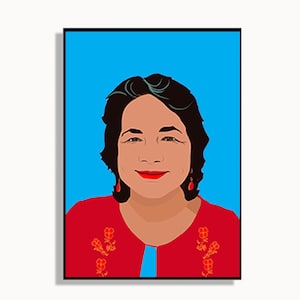 May include: A woman with dark hair and red lipstick is wearing a red blouse with floral embroidery. The background is a solid blue.