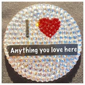 May include: A white round sticker with a red heart and the text "I love anything you love here" in black.