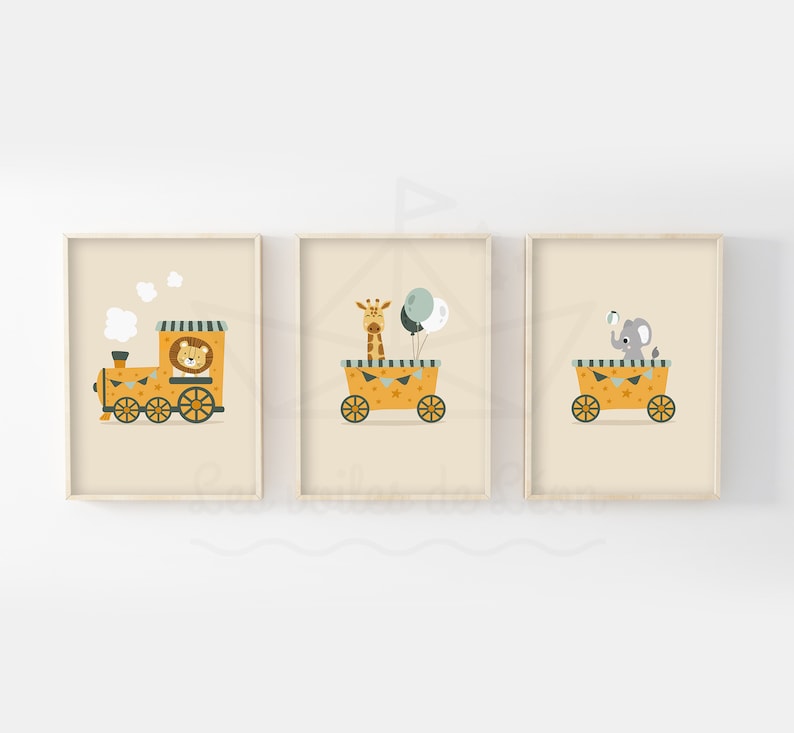 May include: Three framed prints featuring a lion, giraffe, and elephant riding in toy vehicles. The lion is in a yellow train, the giraffe is in a yellow wagon, and the elephant is in a yellow wagon. The prints have a light beige background.