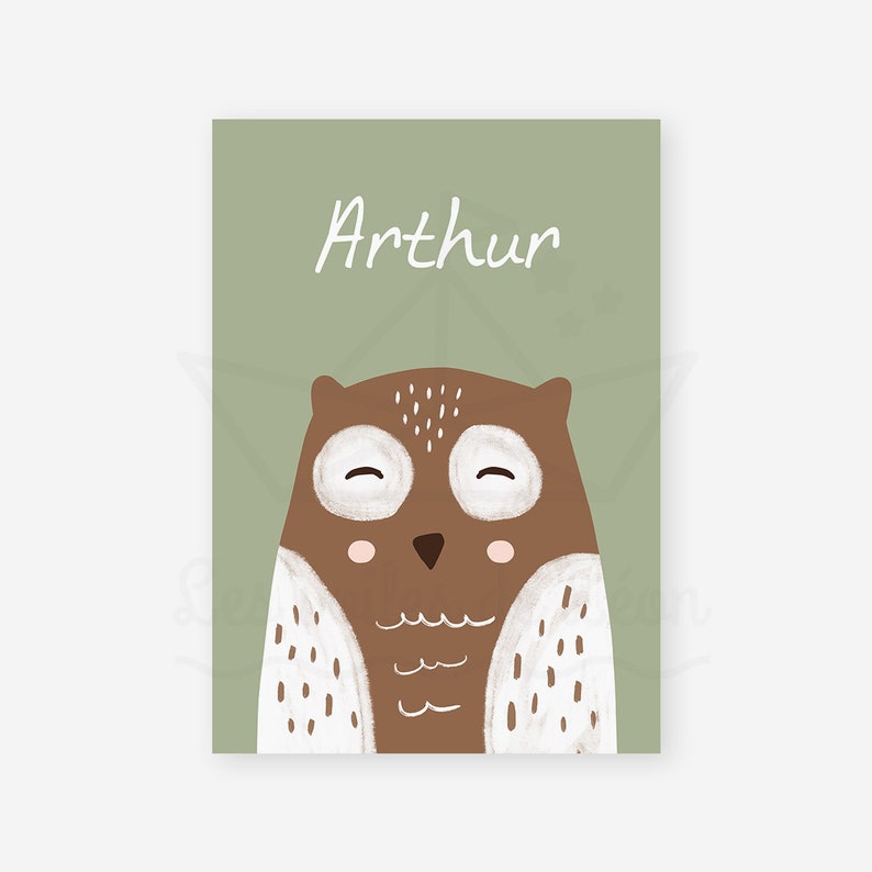 May include: A green card with the name "Arthur" written in white cursive. A brown owl with white spots and closed eyes is in the center of the card.
