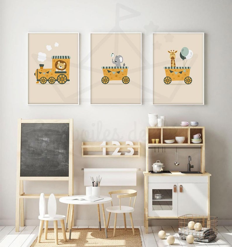 May include: Three framed prints with a yellow background and white frames. Each print features a different animal riding in a yellow wagon. The first print shows a lion in a train, the second print shows an elephant holding a ball, and the third print shows a giraffe holding balloons.