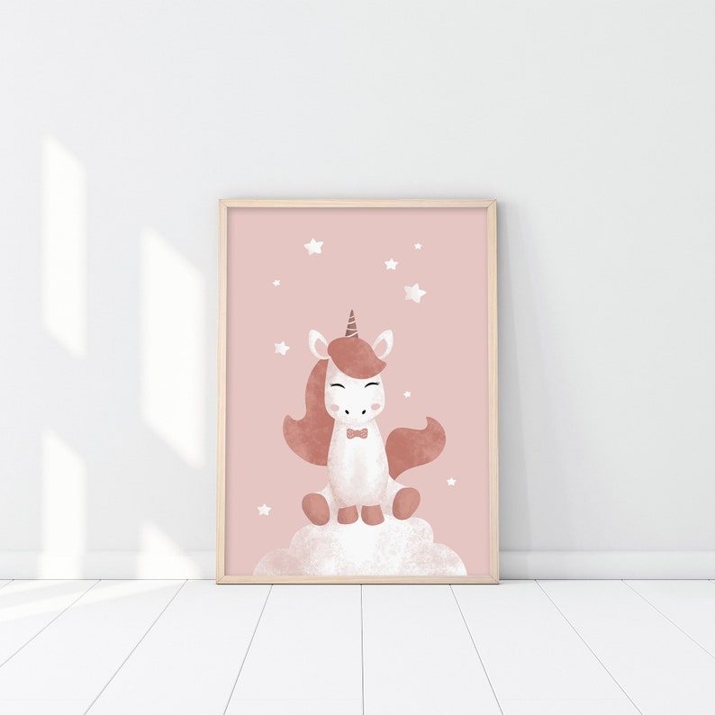 May include: A framed print of a pink watercolour illustration of a white unicorn with a brown mane and tail, wearing a bow tie, sitting on a cloud with stars in the background.