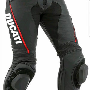May include: Black leather motorcycle pants with red and white accents. The pants have knee pads and the Ducati Corse logo on the left leg.