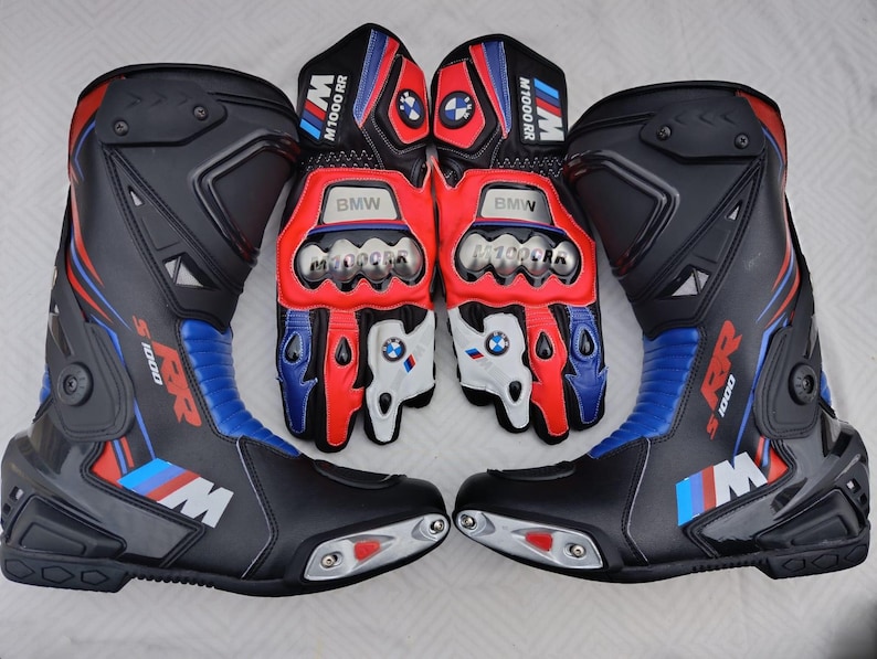 May include: A pair of black, red, and blue motorcycle boots and matching gloves featuring the BMW M1000 RR logo. The boots have protective plates and the gloves include knuckle armor, BMW branding, and the text M1000 RR on the cuffs and fingers.