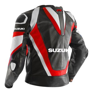 May include: A black, red, and white leather motorcycle jacket with the word "SUZUKI" on the back. The jacket has a white and red stripe design and a white "SUZUKI" logo on the left shoulder.