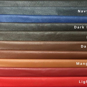 May include: A color palette of leather swatches in various shades, including black, navy blue, blue, dark brown, brown, dark tan, tan, mango tan, red, and light red. Each swatch is labeled with its corresponding color name.