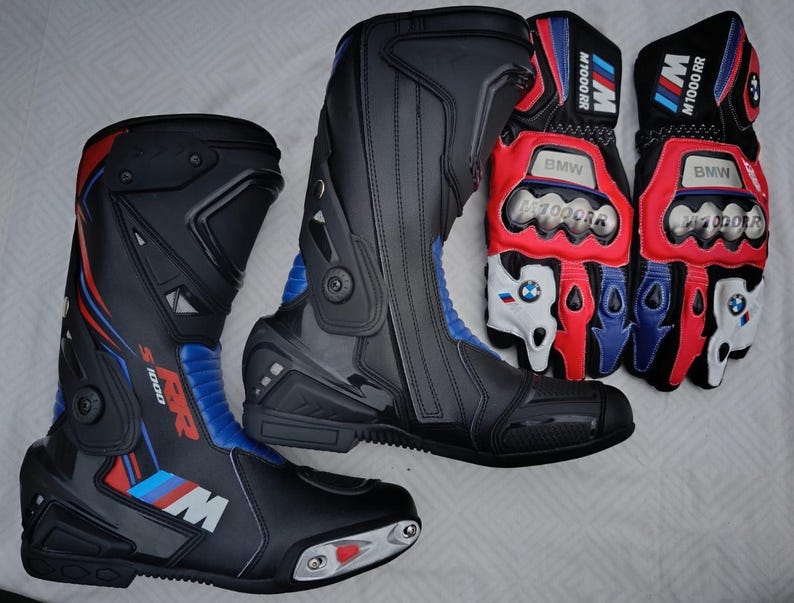 May include: A pair of black, red, and blue motorcycle boots with S 1000 RR branding and a pair of matching black, red, and white motorcycle gloves with BMW M 1000 RR text and logos, featuring protective metal knuckle guards and reinforced panels.