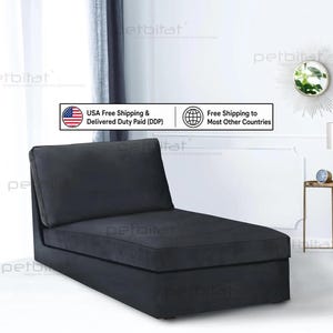 May include: A dark gray armless chaise lounge featuring a rectangular backrest and a long, cushioned seat base. The furniture piece is upholstered in a solid, matte fabric and is positioned at an angle to showcase its simple, clean-lined silhouette.