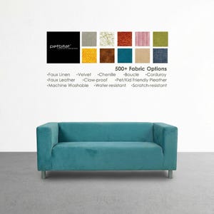 May include: A teal-coloured, modern sofa with a rectangular shape and silver legs. Above the sofa, a display showcases various fabric swatches and the text "500+ Fabric Options". The fabric options include faux linen, velvet, and chenille.
