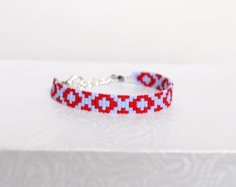 Bright red and pale blue woven bracelet