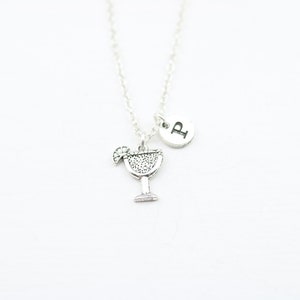 May include: Silver necklace with a charm of a margarita glass and a letter 'P' charm.