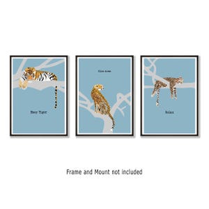 May include: Three framed art prints with illustrations of big cats on branches against a light blue backdrop. The prints show a tiger, cheetah, and leopard, with the phrases "Easy Tiger", "Slow down", and "Relax".