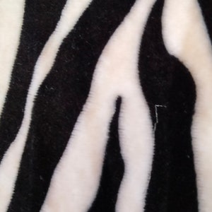 Fleece fabric in black and white with zebra patterns image 1