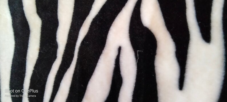 Fleece fabric in black and white with zebra patterns image 1