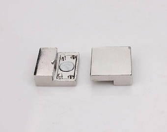 a rectangular magnetic steel clasp in gold or silver color