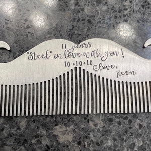 May include: A silver metal comb shaped like a mustache with the inscription "11 years "Steel" in love with you! 10.10.10 Love, Keon"