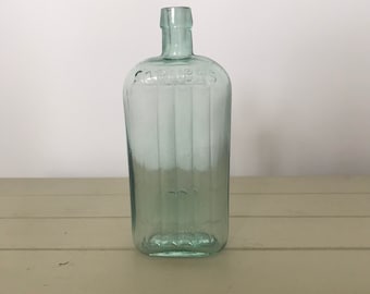 Botella de medicina de fregados de vidrio vintage