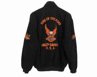 May include: Black Harley-Davidson jacket with orange and white embroidered eagle graphic and text. The jacket features the words "KING OF THE ROAD" and "HARLEY-DAVIDSON U.S.A."