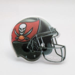 May include: A black and red football helmet with a skull and crossbones logo. The helmet has a white face mask and the words "Two-Time" are visible on the side.