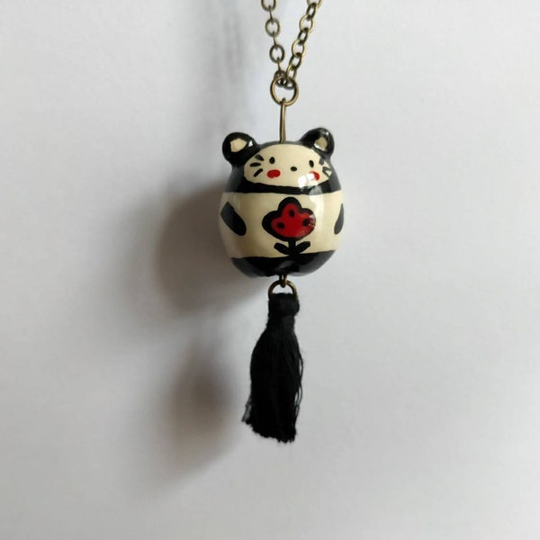 Collier sautoir avec pendentif "chat" en faïence blanche modelé et décoré à la main, avec décor de fleur rouge et pompon noir