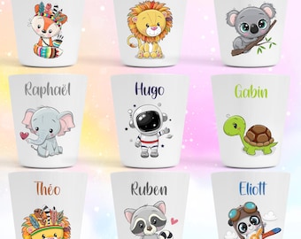 May include: A set of nine white plastic cups, each featuring a unique cartoon character and a name printed above it. Characters include a fox, lion, koala, elephant, astronaut, turtle, lion with feathers, raccoon, and a panda pilot.