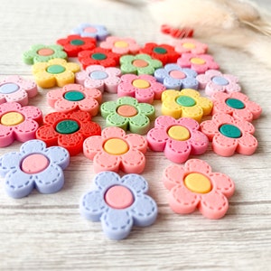 Colorful flower needle minder magnets for embroidery, cross stitch, sewing, and needlecrafts.