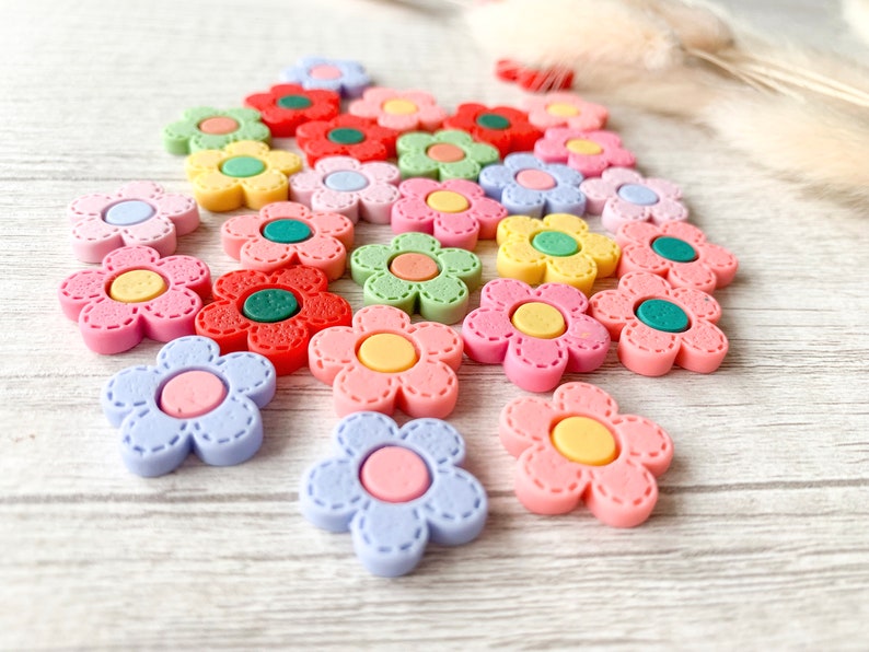 Colorful flower needle minder magnets for embroidery, cross stitch, sewing, and needlecrafts.