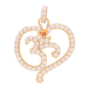 May include: A gold pendant in the shape of a heart with a stylized Om symbol inside. The pendant is decorated with small white stones.
