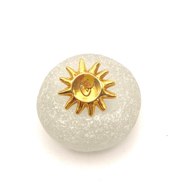 CHRISTIAN LACROIX pins in the shape of a sun engraved CL in the center in gold metal