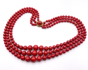 DAVID GRAU, Red glass pearl necklace with clasp signed dag, 3 rows