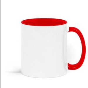 A white ceramic mug with a red interior and handle.