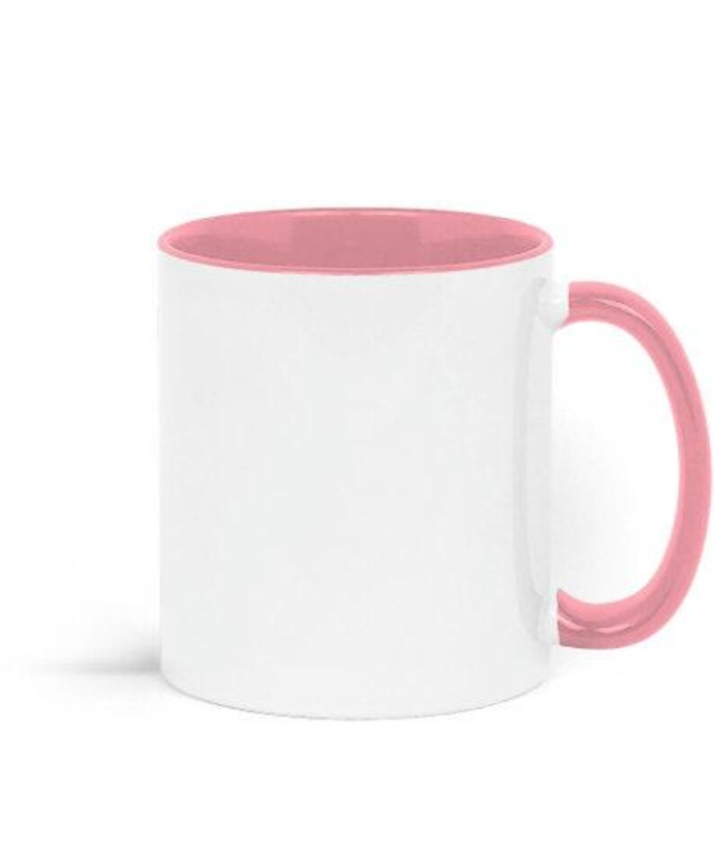 A white ceramic mug with a pink interior and handle.