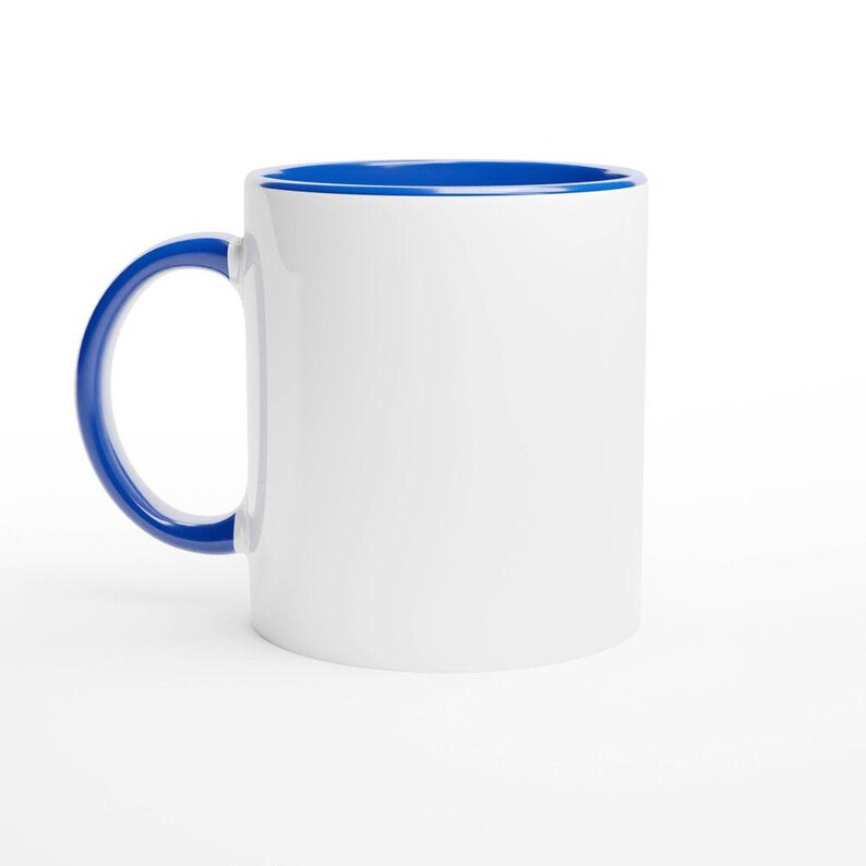 A white ceramic mug with a blue rim, sitting on a white background.