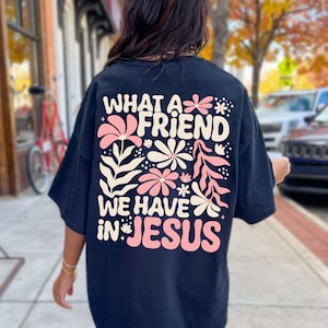 May include: Black t-shirt with a pink and cream floral design and the text "What a Friend We Have in Jesus".