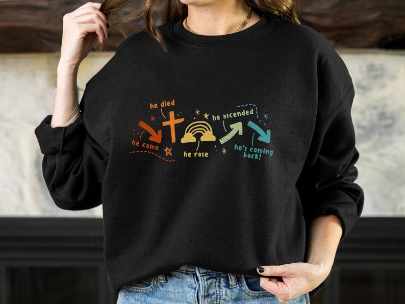 May include: Black sweatshirt with a graphic design of a cross and a rainbow. The text on the graphic reads "he died", "he came", "he rose", "he ascended", "he's coming back!"