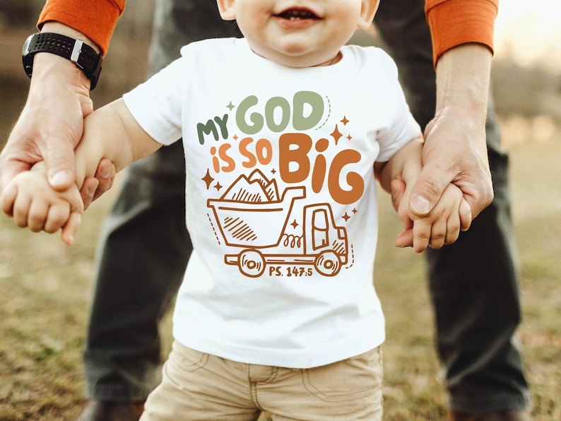 May include: A white toddler t-shirt with a brown truck graphic and the text "My God is so Big" with a scripture reference "PS. 147.5".
