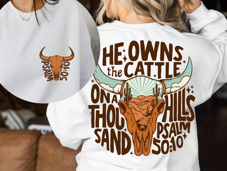 May include: White sweatshirt featuring a brown bull skull graphic with the text "Psalm 50:10" on the front. The back of the sweatshirt displays a larger bull skull design with the words "He owns the cattle on a thousand hills Psalm 50:10".