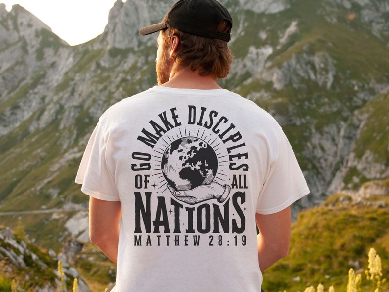 May include: White t-shirt with a black graphic print of a hand holding a globe with the text "Go Make Disciples of All Nations Matthew 28:19"