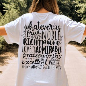 May include: White t-shirt with black text on the back. The text includes the words "whatever is true, noble, right, pure, lovely, admirable, praiseworthy, excellent" and "Think about such things" with a reference to Philippians 4:8.