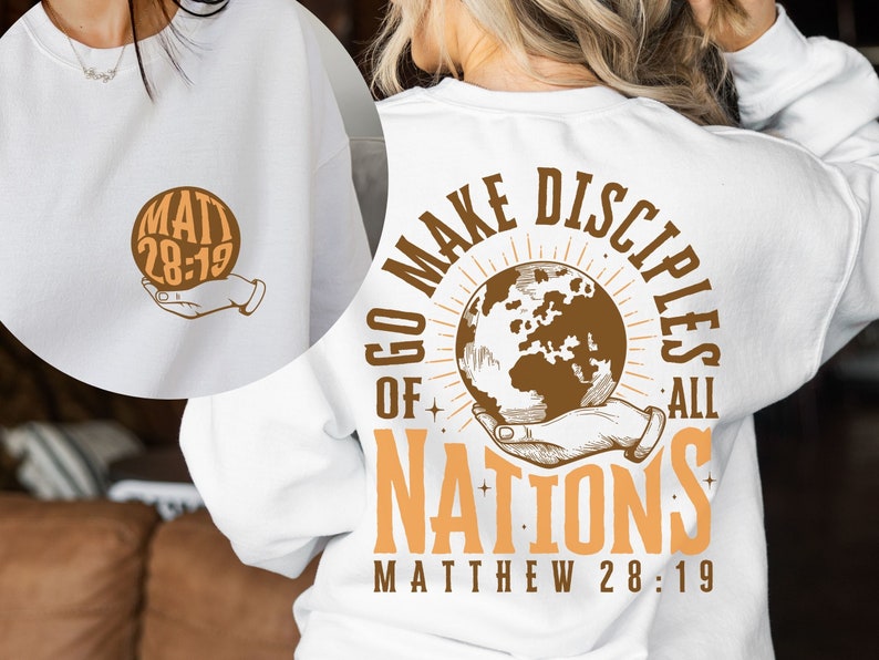 May include: White sweatshirt with a brown graphic of a hand holding a globe with the text "Go Make Disciples of All Nations Matthew 28:19" on the back and the text "Matt 28:19" on the front.
