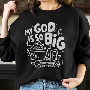 May include: Black sweatshirt with a white graphic design that says "My God is so Big" with a drawing of a dump truck filled with mountains. The text "PS. 147:5" is below the truck.