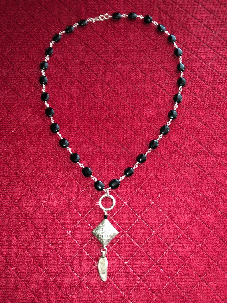 Clasp is a Silver Hook 19.5 inch Silver Wire Wrapped Onyx Bead Necklace with a 3 inch Silver and Onyx Pendent